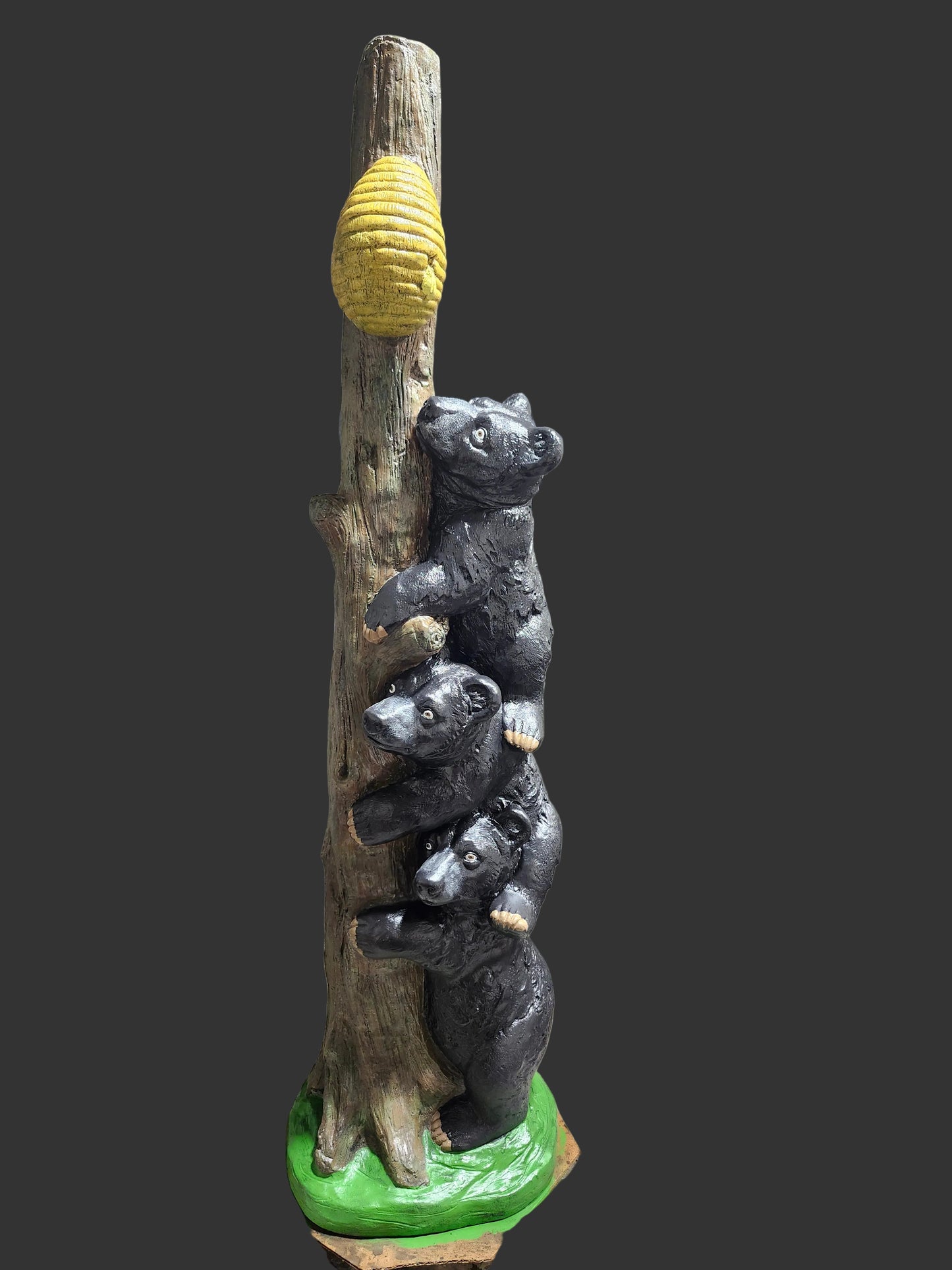 Bears climbing tree to honey pot