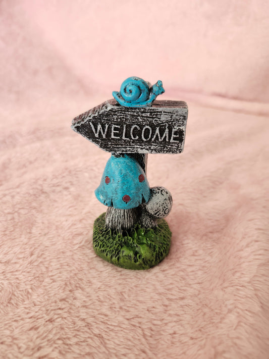 Welcome mushroom sign with snail