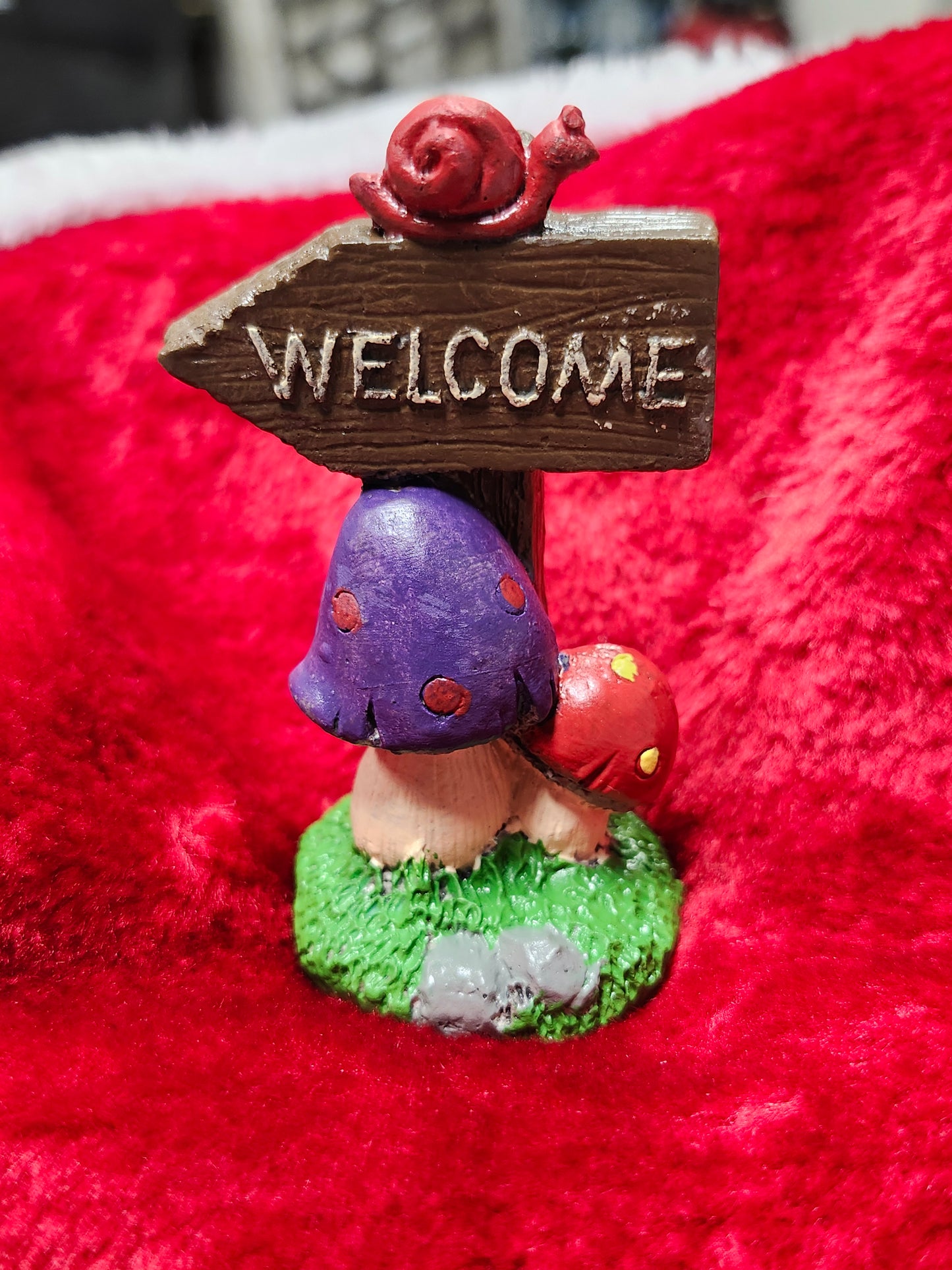 Welcome mushroom sign with snail