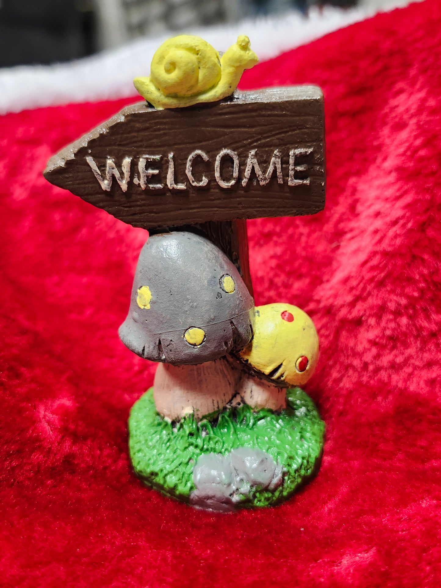 Welcome mushroom sign with snail